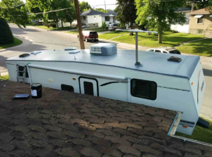 Motorhome roof maintenance on residential street.